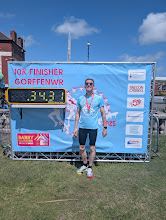 Runner posing with race time sign after Barry 10km